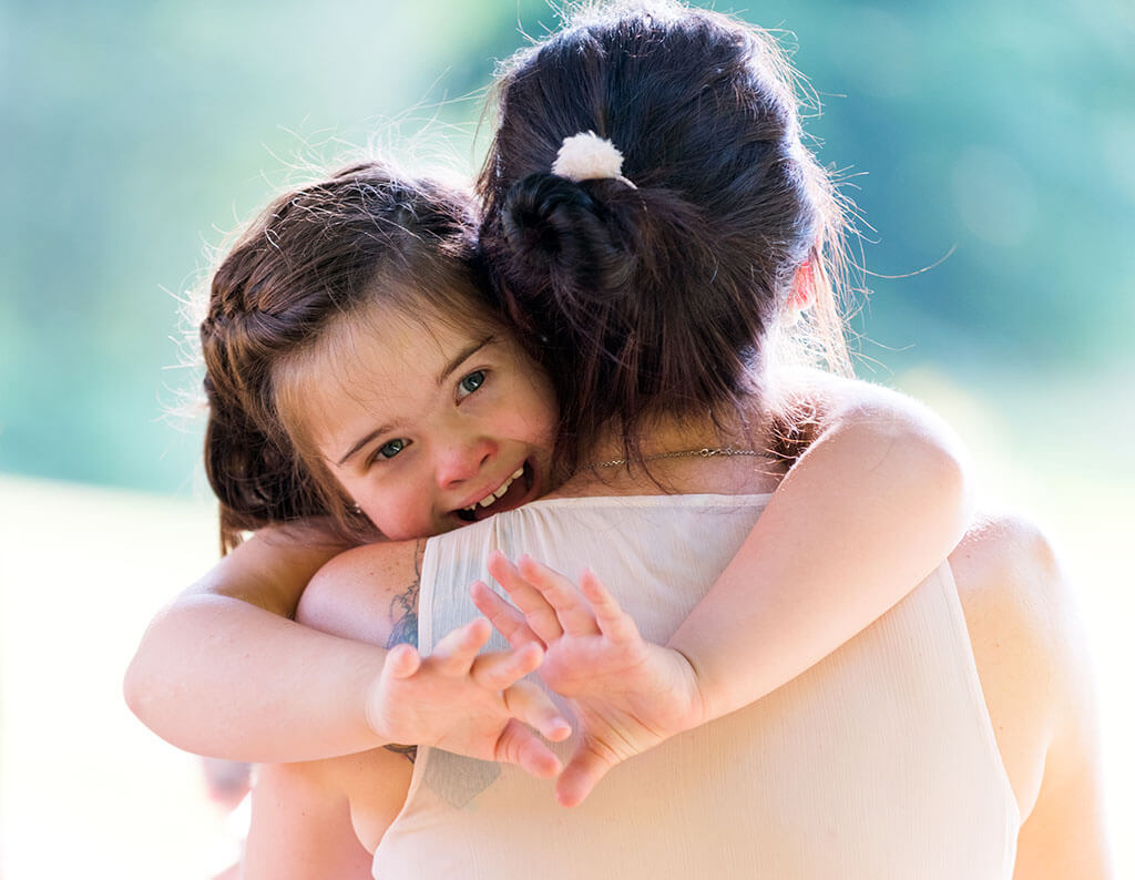 Mother and daughter hugging
