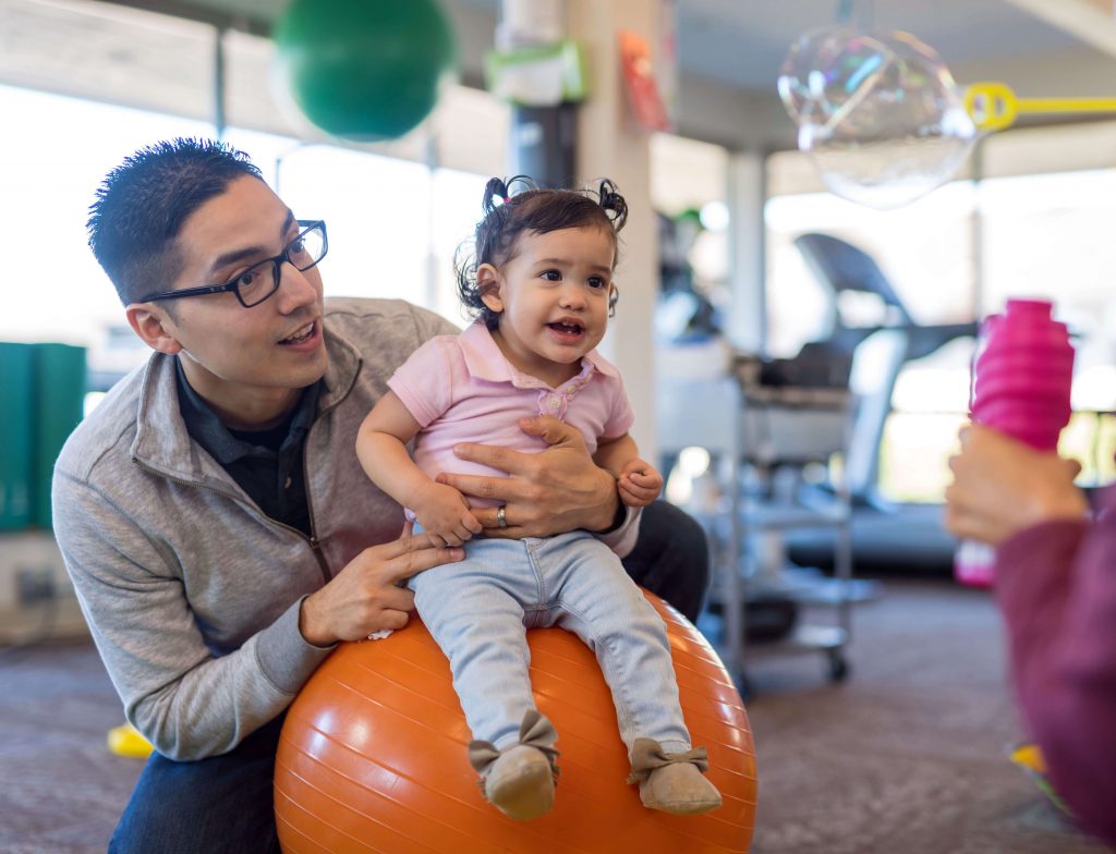 Dad with toddler at occupational therapy.