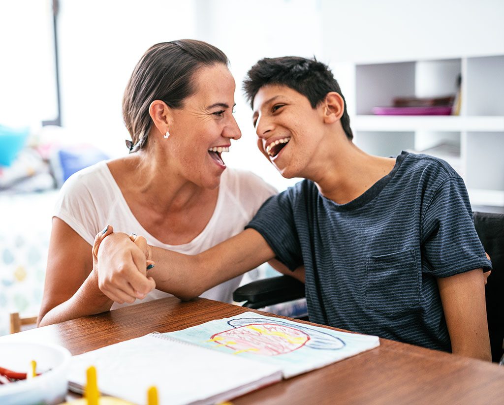 Mother with teenage son with cerebral palsy