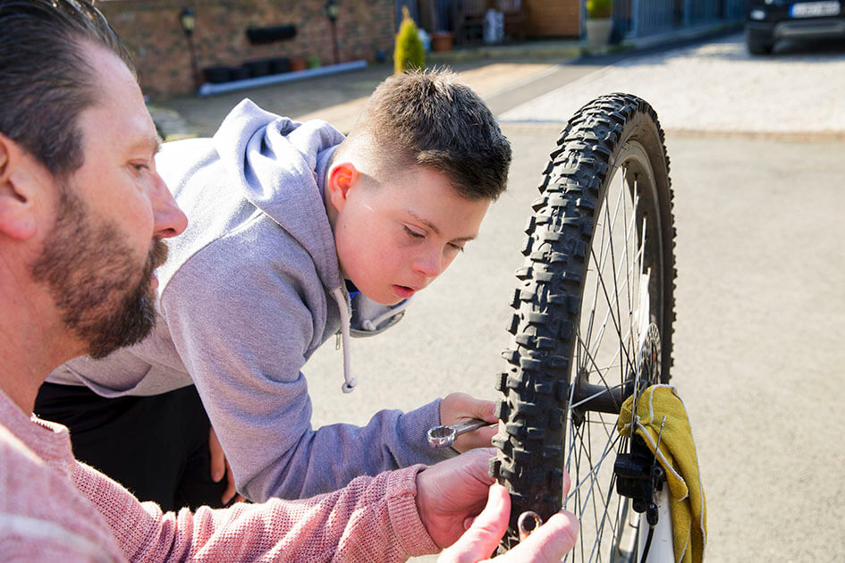 Father and son fixing a bike.