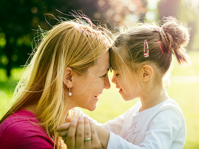 Mother and dauther close up in the park.