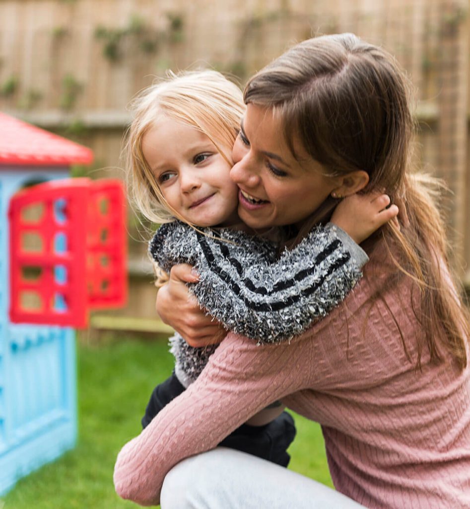 Mother having fun with daughter in the backyard.