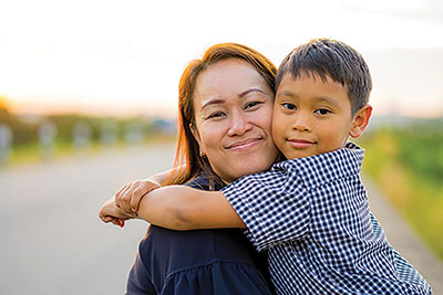 A young boy hugging his mum