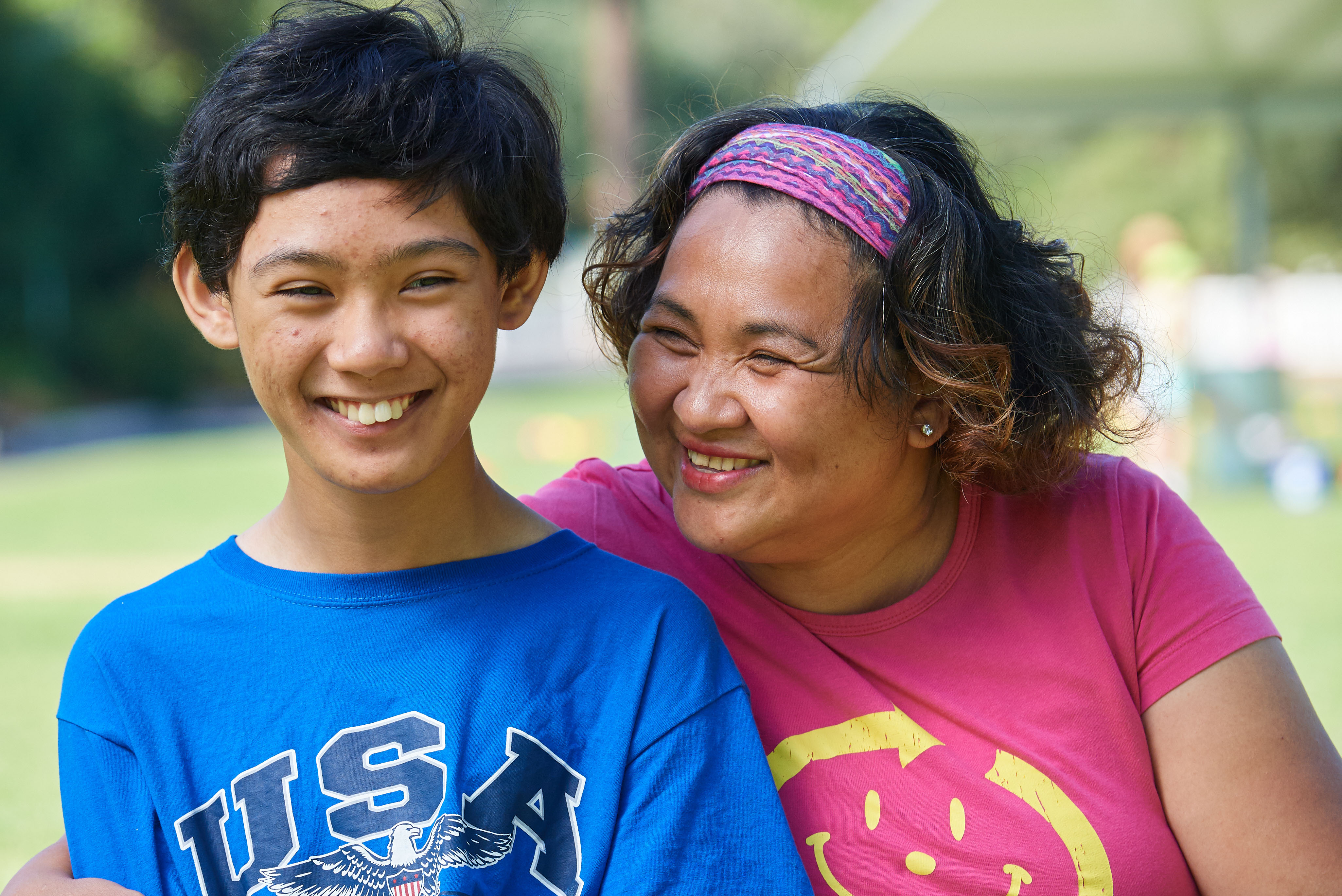 A mother and son smiling together.