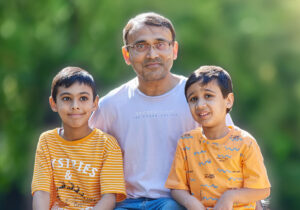 A father sitting with his two sons.